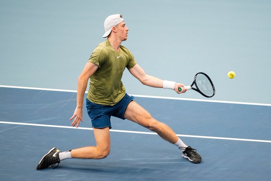 Denis Shapovalov slides and hits a forehand