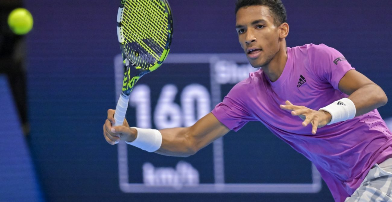 Felix Auger-Aliassime winds up for a forehand.