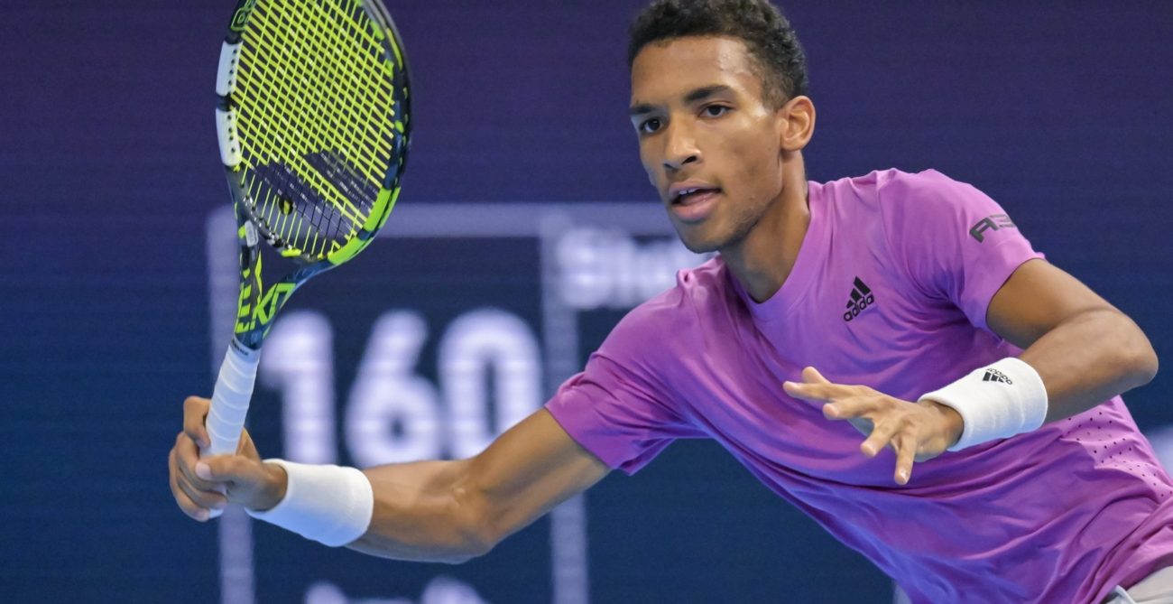 Felix Auger-Aliassime winds up for a forehand.