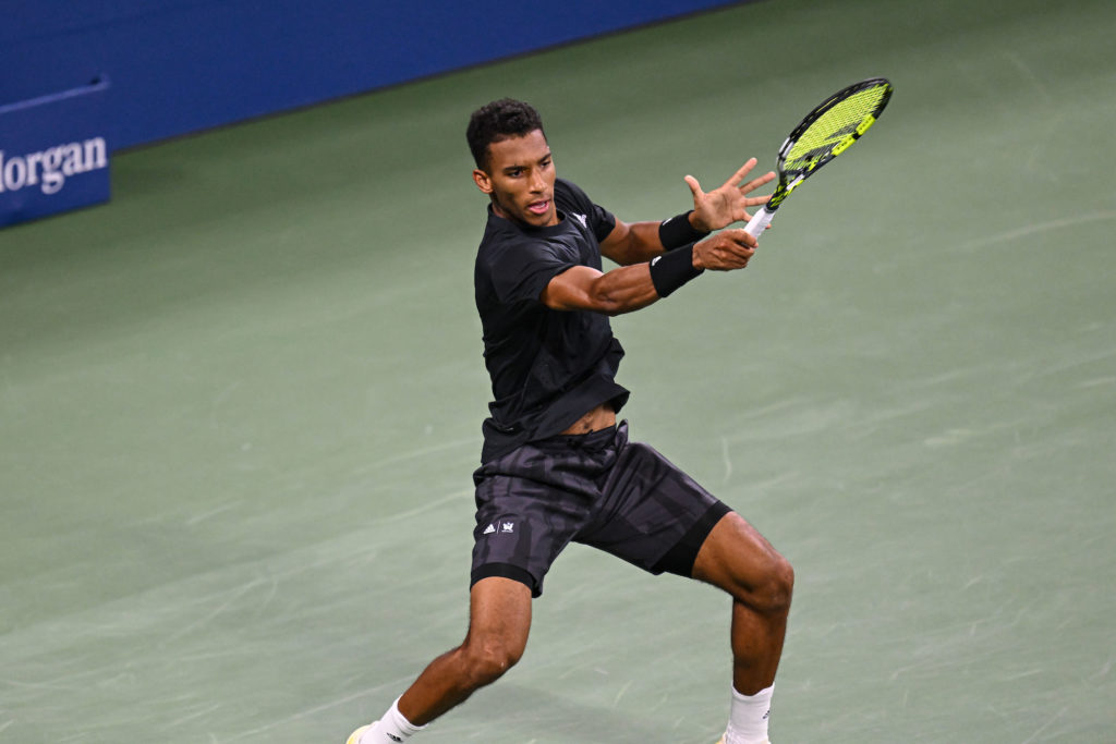 Felix Auger-Aliassime hits a forehand.