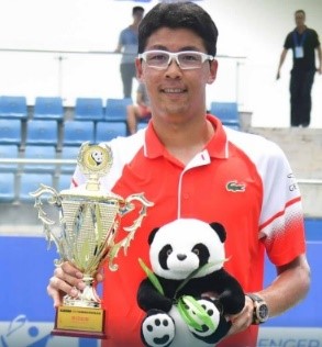Hyeon Chung holds a trophy and a stuffed panda