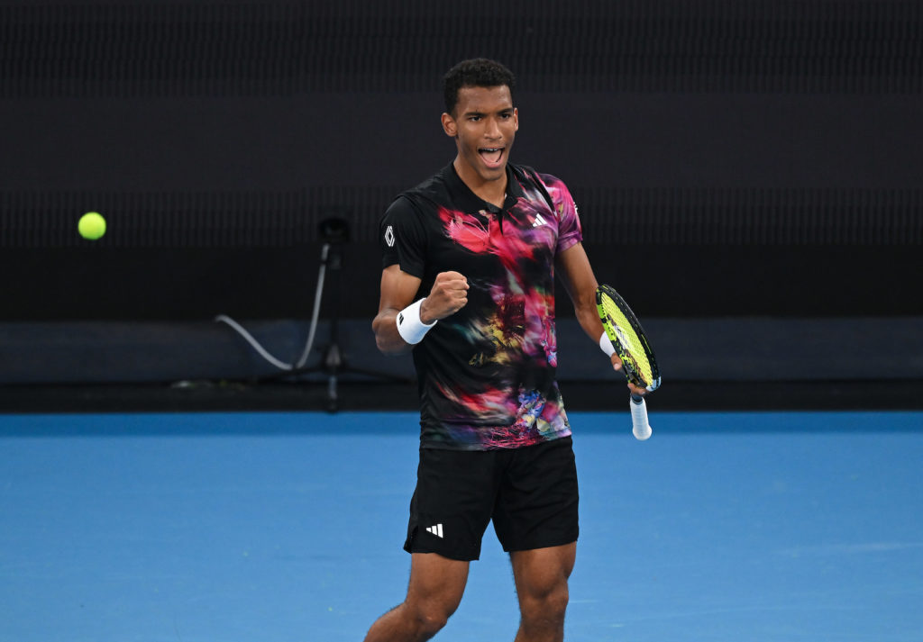 Felix Auger-Aliassime pumps his fist and yells.