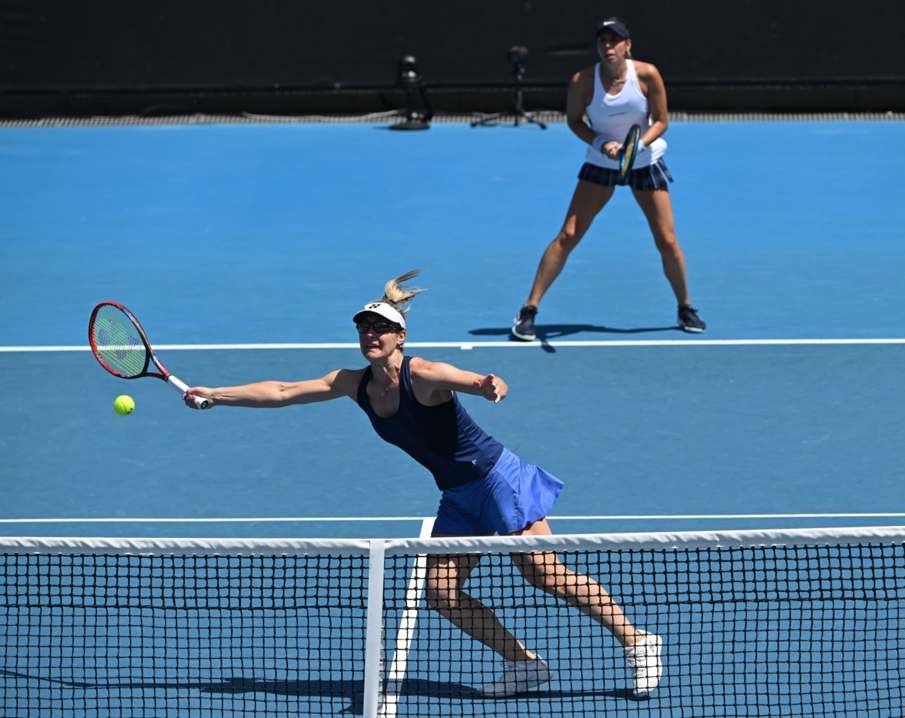 Gabriela Dabrowski lunges to hit a forehand volley.