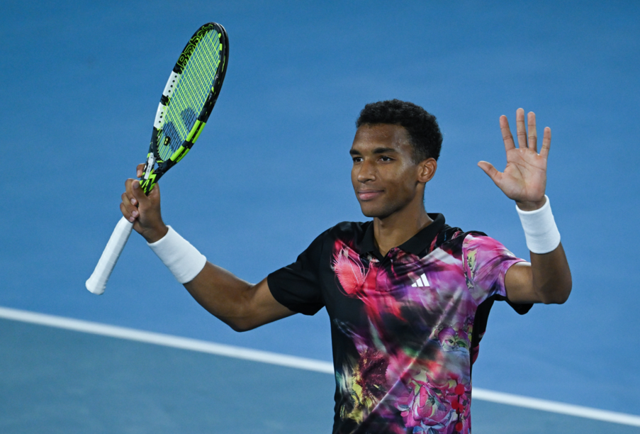 Felix Auger-Aliassime waves to the crowd.