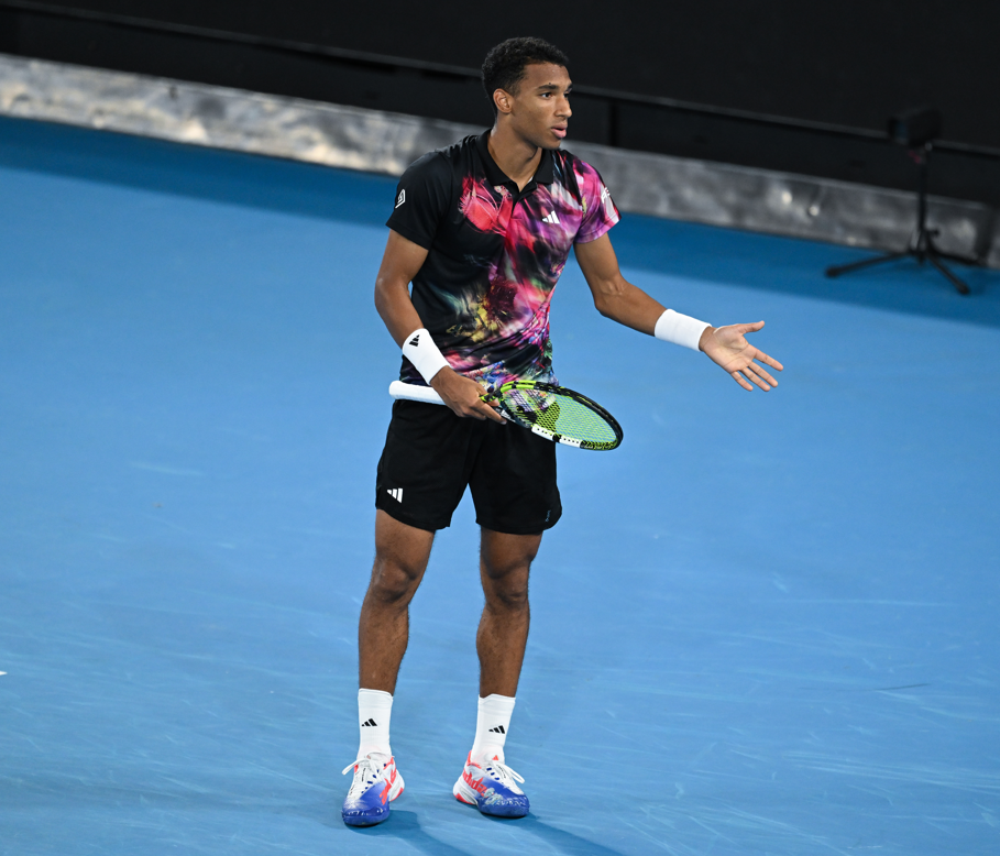 Felix Auger-Aliassime gestures and argues.
