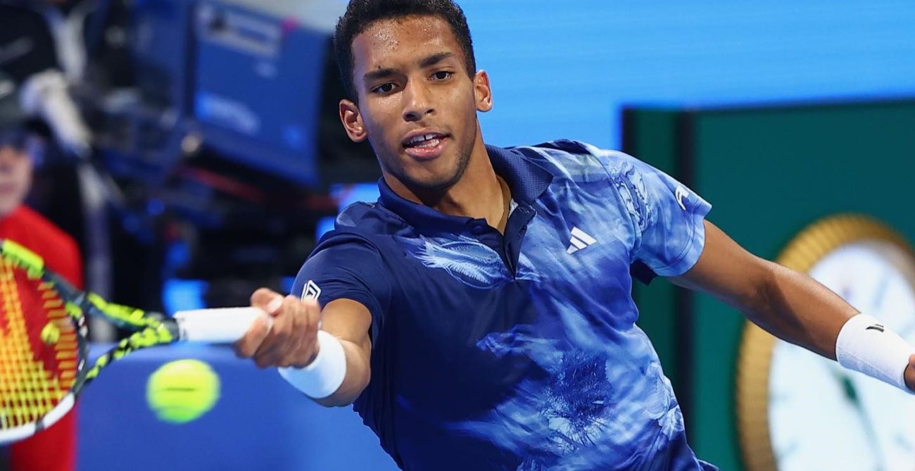 Felix Auger-Aliassime lunges to hit a forehand.