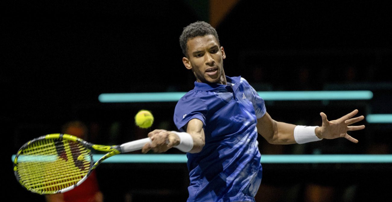 Felix Auger-Aliassime hits a forehand.