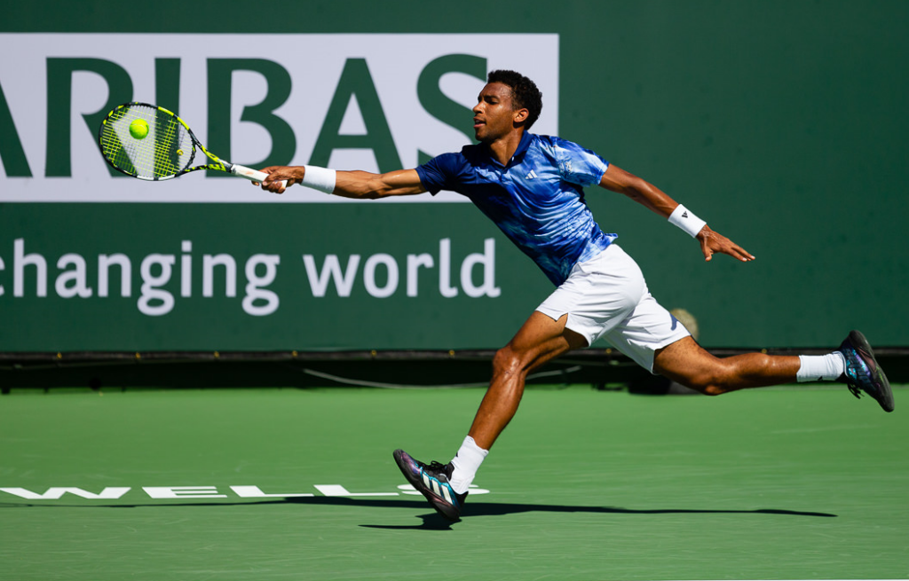 Felix Auger-Aliassime lunges for a forehand.