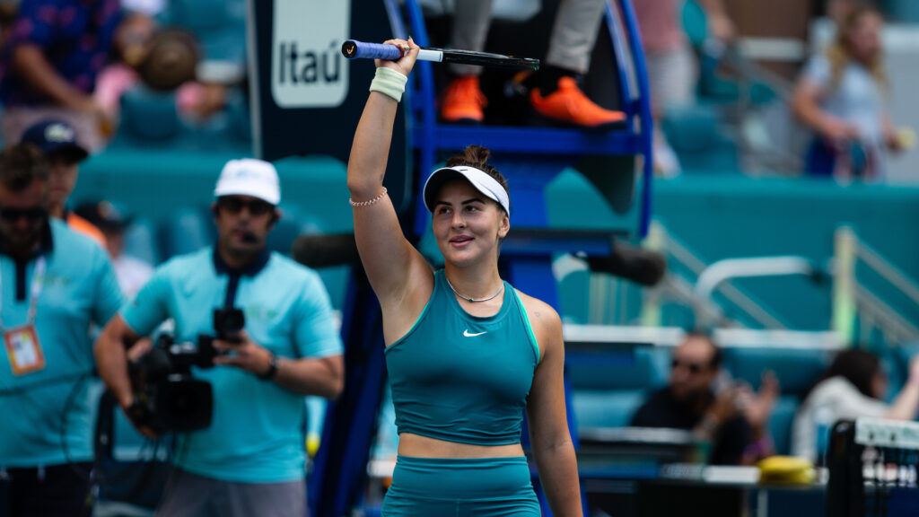 Bianca Andreescu raises her racket over her head to acknowledge the crowd.