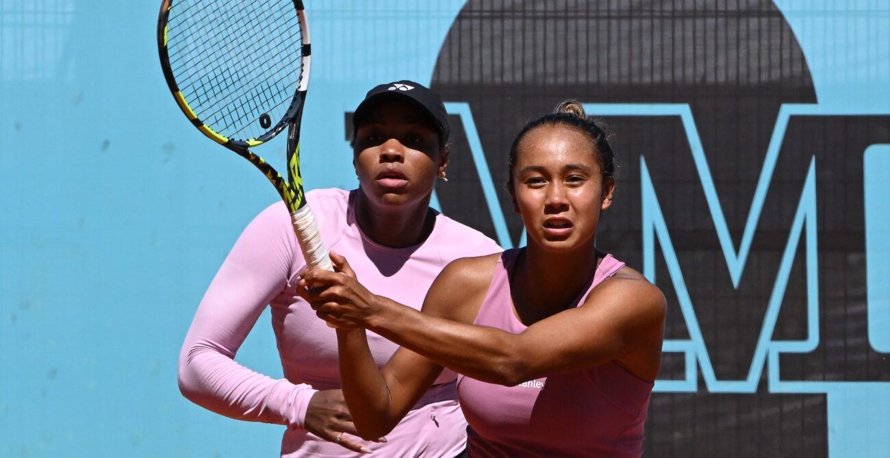 Leylah Fernandez follows through on a volley with Taylor Townsend standing behind her.