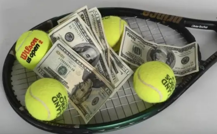 Tennis balls and dollar bills on a tennis racket.