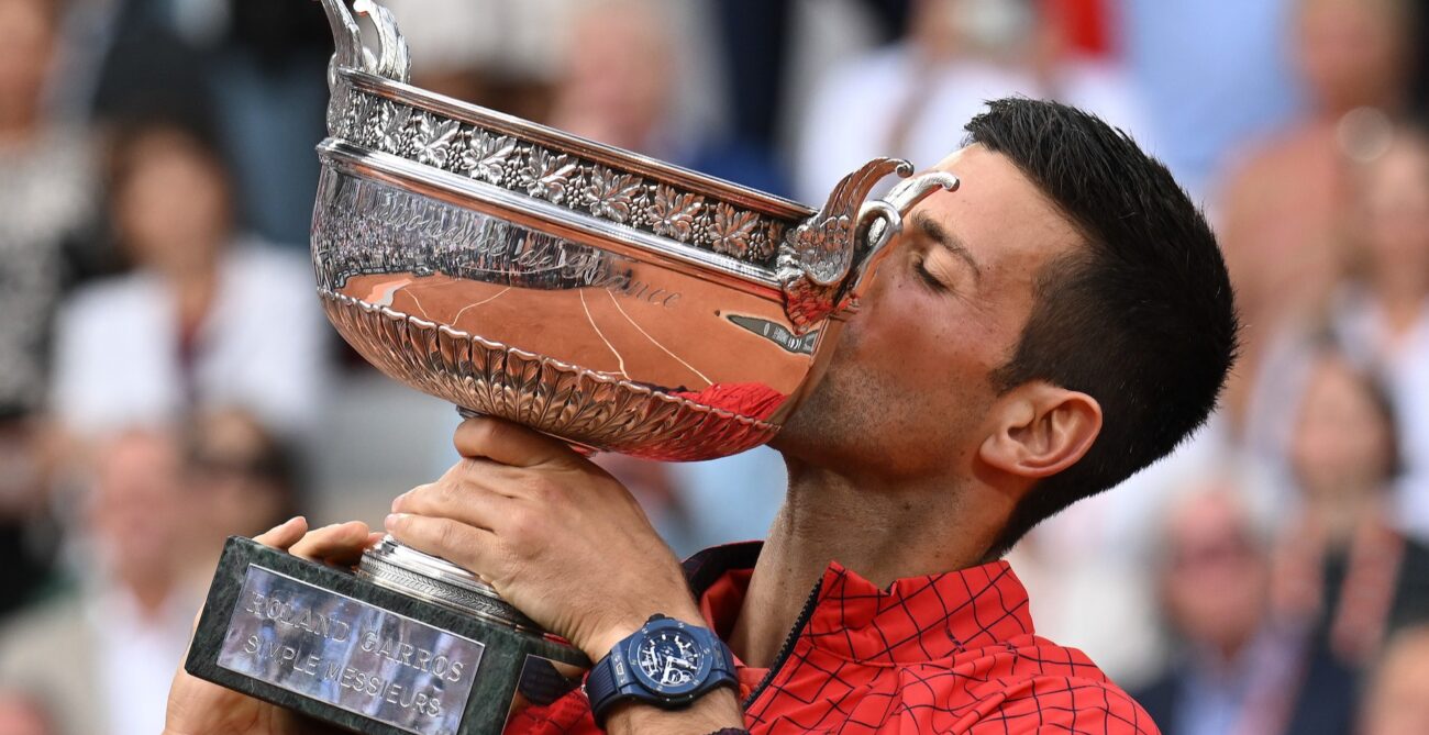 Novak Djokovic kisses the Roland-Garros trophy.