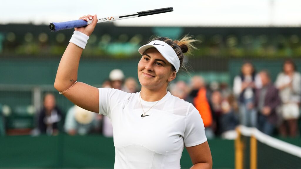 Bianca Andreescu raises her racket over her head to acknowledge the crowd.