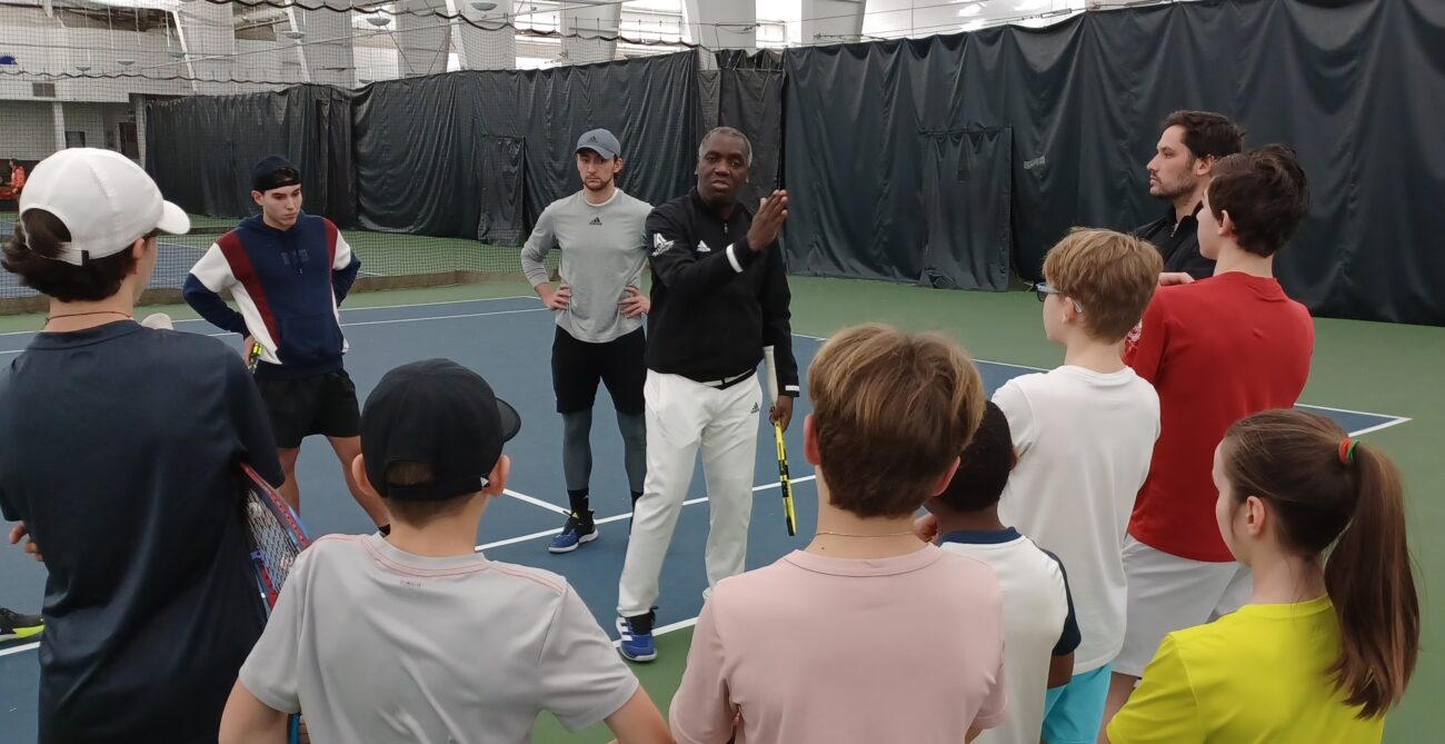 Sam Aliassime speaks to a group of students at his academy.