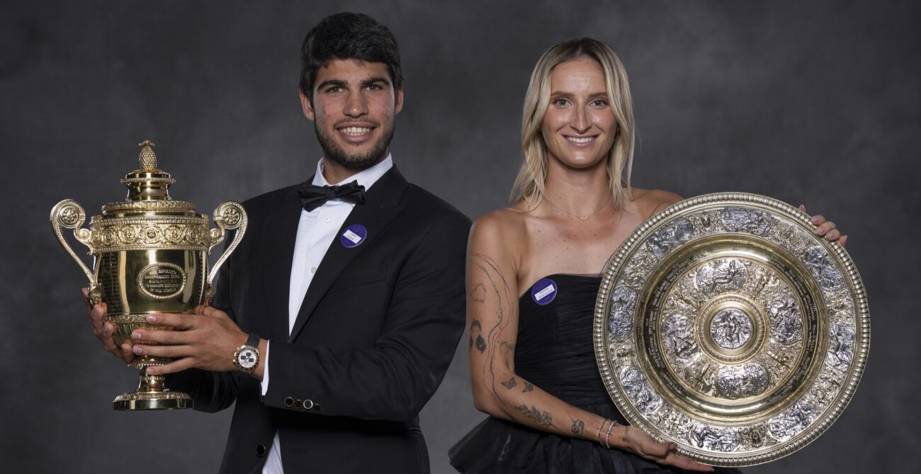 Carlos Alcaraz (left) and Marketa Vondrousova hold up their trophies at the Wimbledon champions ball.