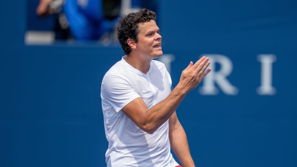 Milos Raonic gestures with his hand.