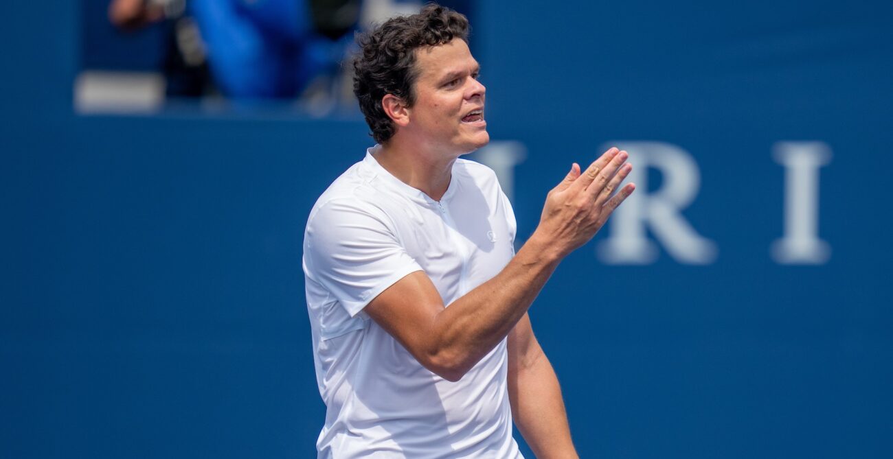 Milos Raonic gestures with his hand.