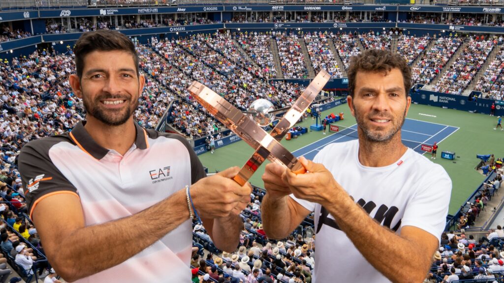 Jean-Julien Rojer and Marcelo Arevalo hold up the trophy in front of the crowd at Sobeys Stadium.