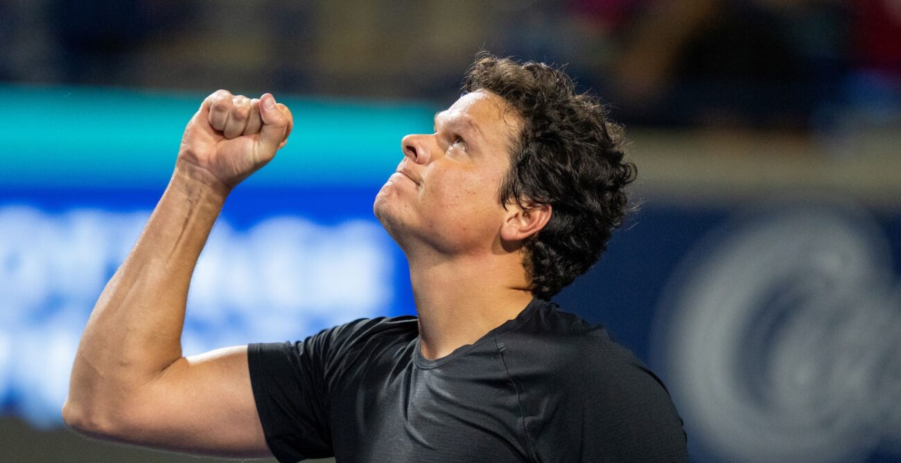 Milos Raonic pumps his and looks up at the sky.