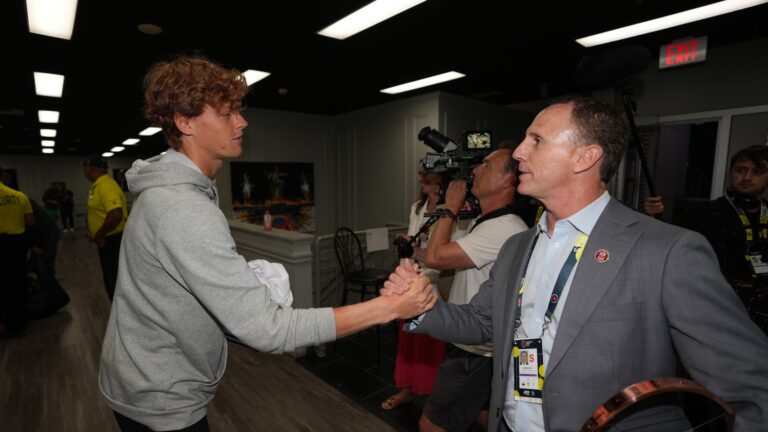 Gavin Ziv (right) shakes hands with Jannik Sinner in the player lounge.