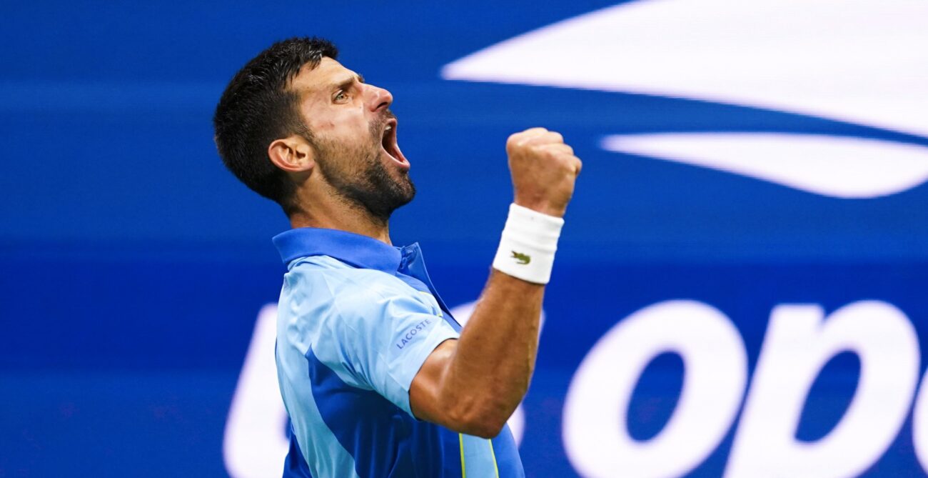 Novak Djokovic pumps his fist and yells.