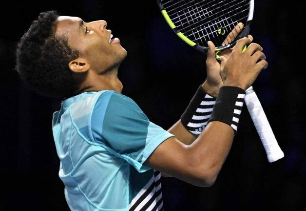 Felix Auger-Aliassime looks up at the sky in relief.