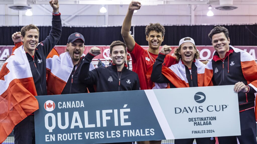 Team Canada holds up a "Qualified" sign