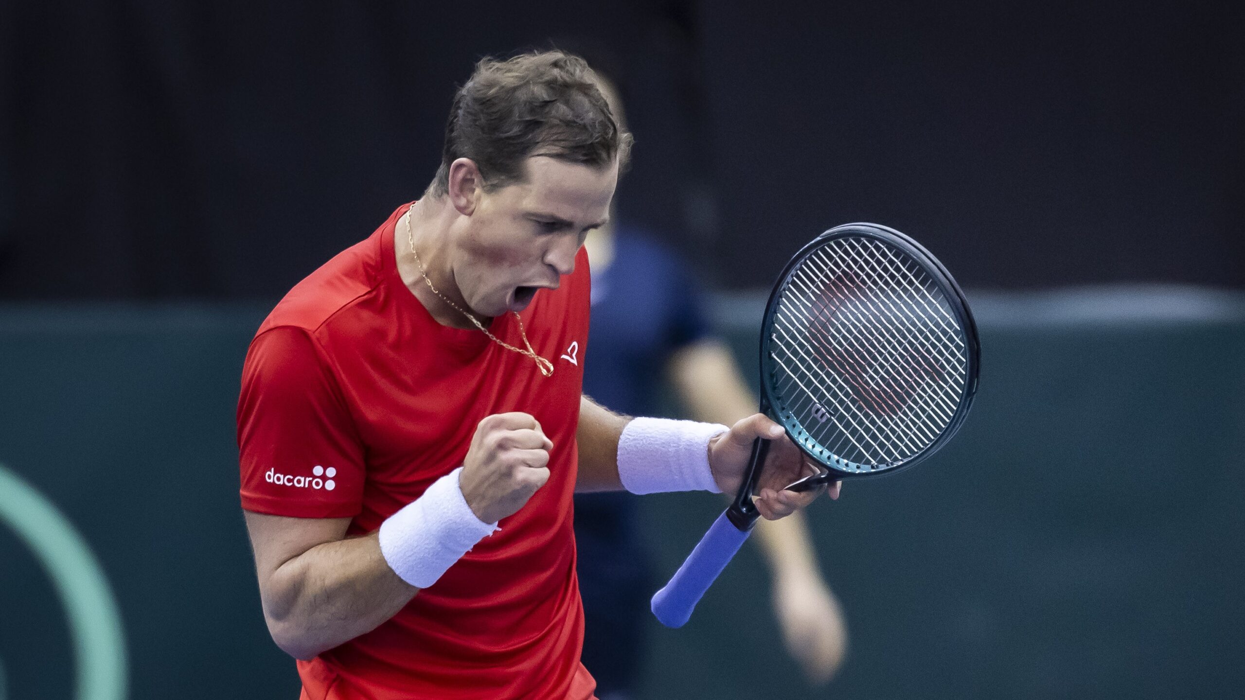 Vasek Pospisil pumps his fist and yells. He and Gabriel Diallo both won on Friday at the Davis Cup in Montreal.