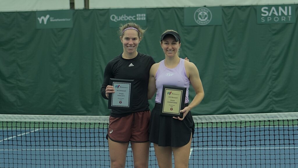 Jessie Aney (left) and Catherine Harrison hold up their Brossard trophies.