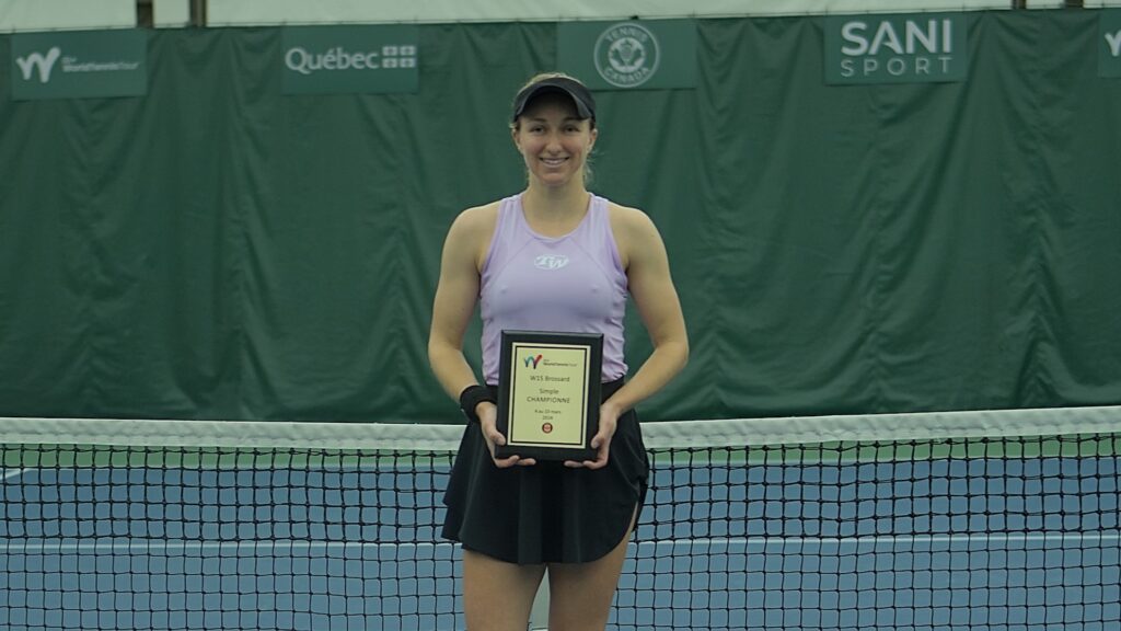 Catherine Harrison holds the Brossard trophy.
