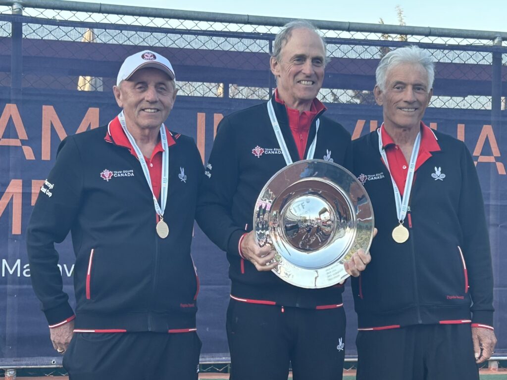 Canada's over 75 team holds up their trophy at the ITF Masters World Team Championships