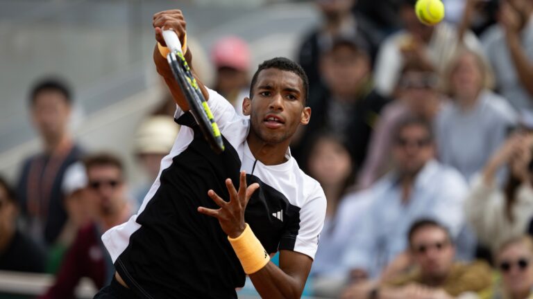 Felix Auger-Aliassime follows through on a serve during his win over Yoshihito Nishioka at the French Open.