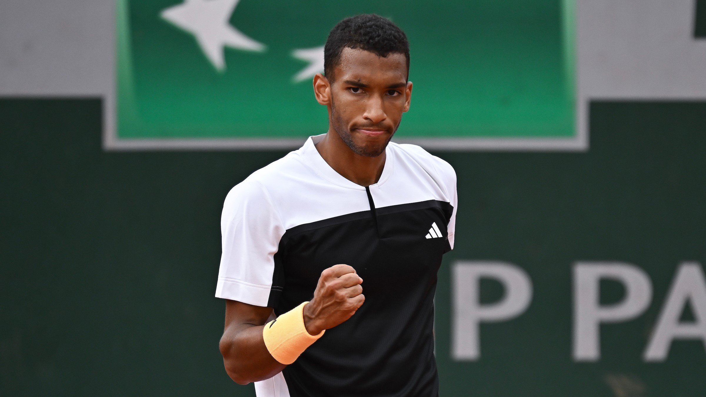 Felix Auger-Aliassime pumps his fist. He easily wrapped up his third-round win over Ben Shelton at the French Open on Saturday. Denis Shapovalov and Bianca Andreescu will also play.